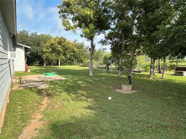 View of yard with view of scattered trees and cooling unit | Image 5
