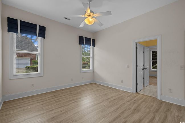 Spare room with light wood-style flooring and a ceiling fan | Image 24