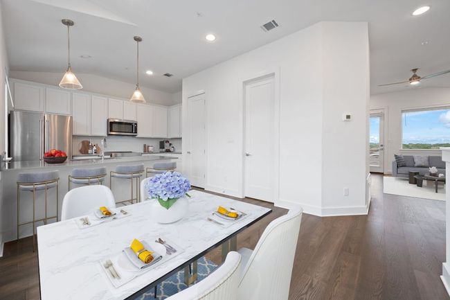 digital staging. Dining room featuring recessed lighting, dark wood-style floors, lofted ceiling, and ceiling fan | Image 5