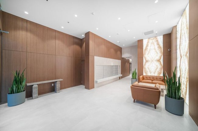 Common area featuring wood walls, recessed lighting, and a high ceiling | Image 18