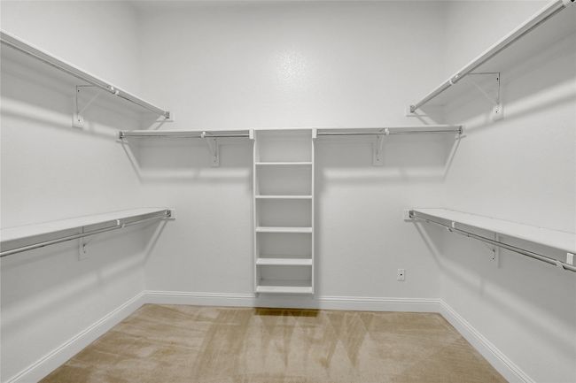 Spacious closet with light colored carpet | Image 16
