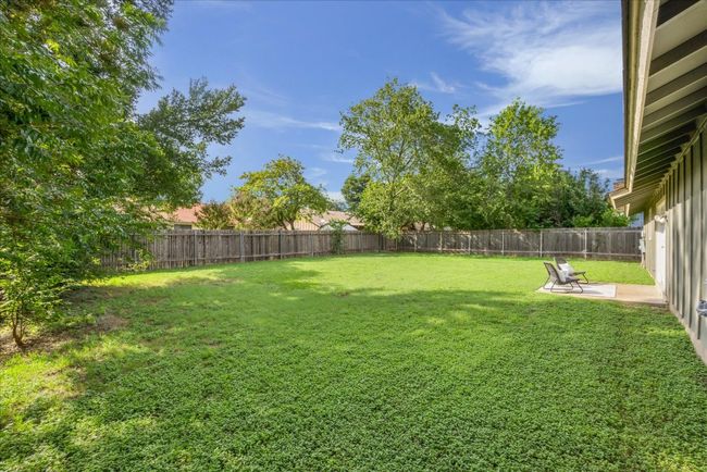 Fenced backyard with a patio area | Image 30