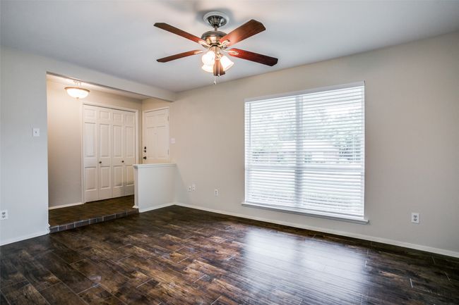 Living room featuring a ceiling fan and wood finished floors | Image 5
