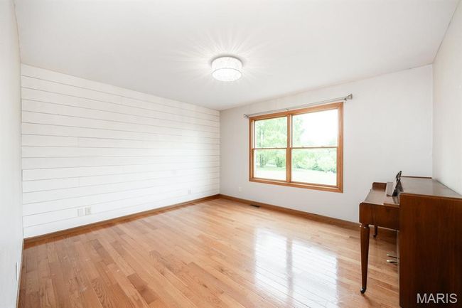 Unfurnished room featuring baseboards and light wood finished floors | Image 26