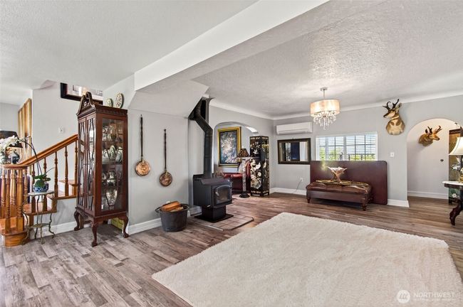 Living Room with TV/Library to the forefront and left. | Image 19