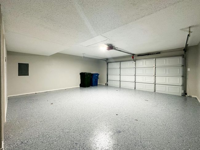 Garage with electric panel and baseboards | Image 12