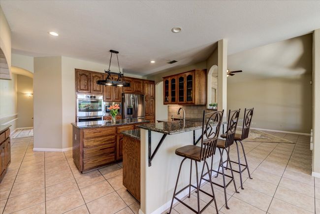 Chef's Kitchen featuring ample cabinetry, large pantry, propane cooktop plus double ovens and stainless appliances. Spacious and functional. | Image 7