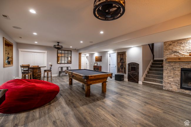 Recreation room with a fireplace, wood finished floors, recessed lighting, and billiards table | Image 54