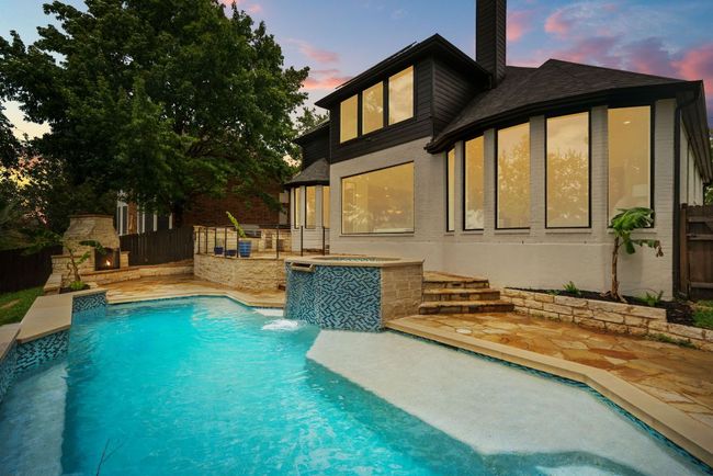 The sparkling heated pool is the centerpiece of the backyard, offering resort-style relaxation just steps from your door. | Image 28