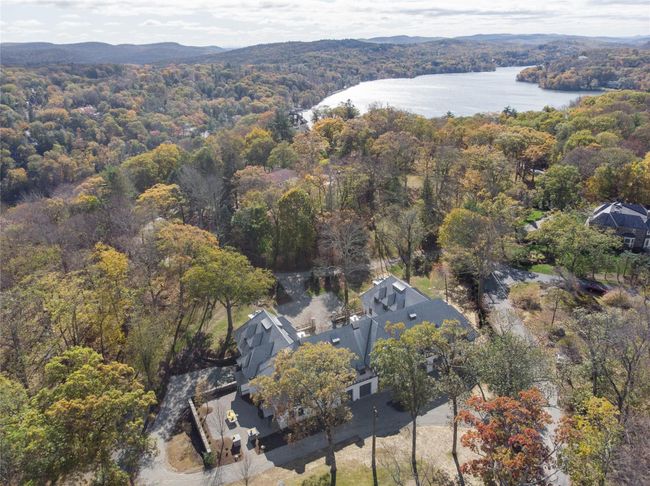 Aerial view of property and surrounding area with a heavily wooded area and a water and mountain view | Image 4