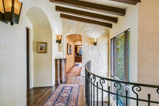 Hall featuring arched walkways, beamed ceiling, and dark wood finished floors | Image 27