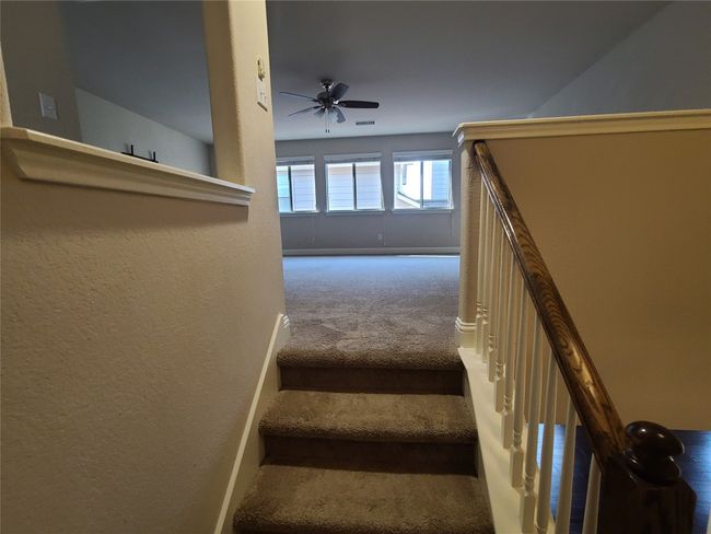 Stairway featuring carpet, a ceiling fan, and a textured wall | Image 28
