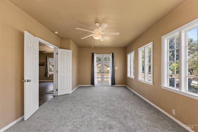 Spare room with carpet flooring, plenty of natural light, french doors, and ceiling fan | Image 23