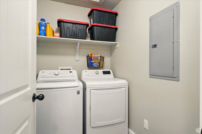 Laundry area featuring electric panel and washer and dryer | Image 18