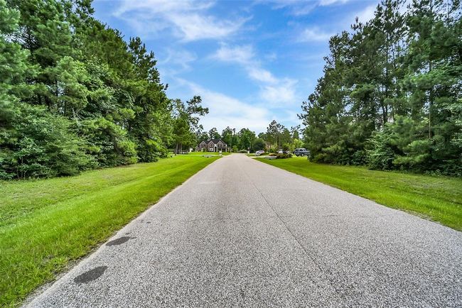 Build your dream home on this stunning wooded lot, where possibilities abound—whether you envision a timeless traditional design or a sleek modern retreat. Located in the prestigious Bender’s Landing Estates, this property offers more than just beautiful surroundings. | Image 8
