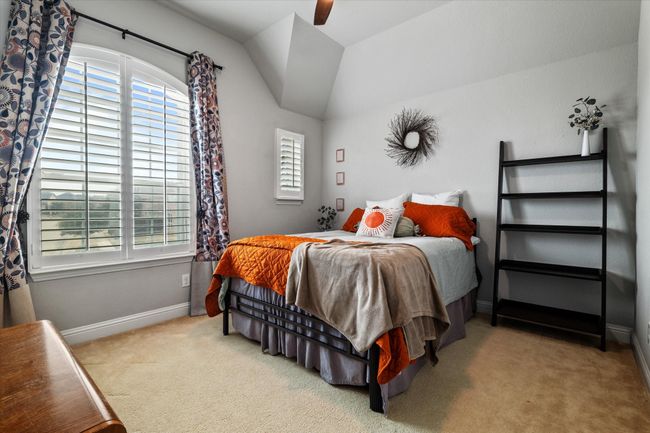 Bedroom with ceiling fan, light carpet, and vaulted ceiling | Image 34