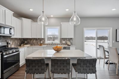 Modern and functional, this kitchen is equipped with granite kitchen countertops, stainless steel appliances, and a luxurious gas cooktop. | Image 3