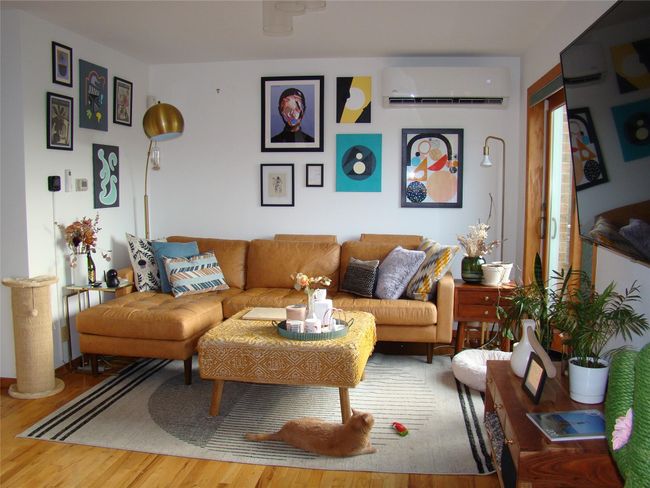 Living room featuring wood-type flooring and an AC wall unit | Image 14