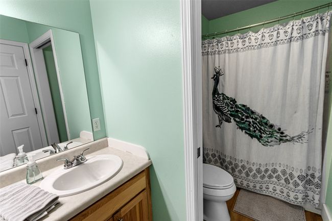 Bathroom with vanity and a shower with curtain | Image 65