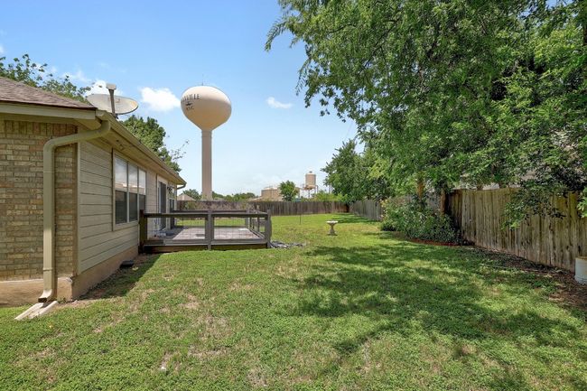 Fenced backyard with a wooden deck | Image 27