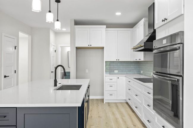 The kitchen has all new stainless steel appliances, new cabinets, new lighting & new flooring. | Image 11