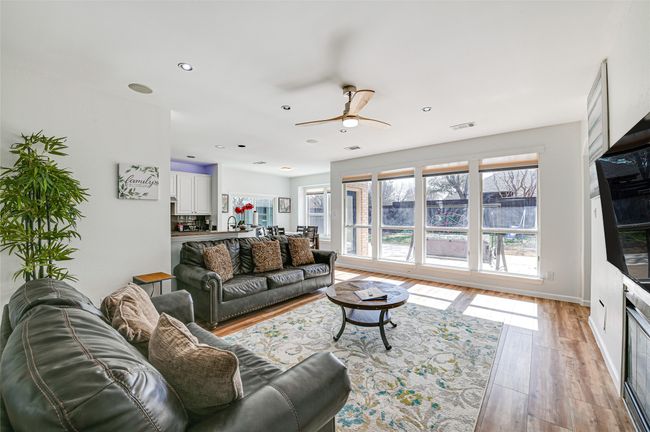 Living room featuring sink, light wood-type flooring, and ceiling fan | Image 7