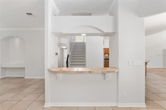 BAR BRIDGES FORMAL AREAS TO KITCHEN | Image 13