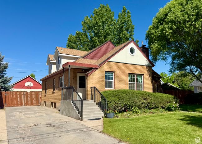 View of front facade with a chimney and roof with shingles | Image 6