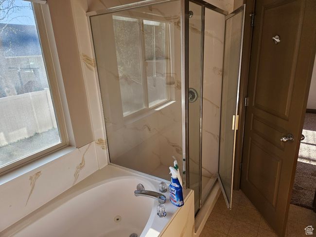 Full bath with tile patterned flooring, a marble finish shower, and a jetted tub | Image 31