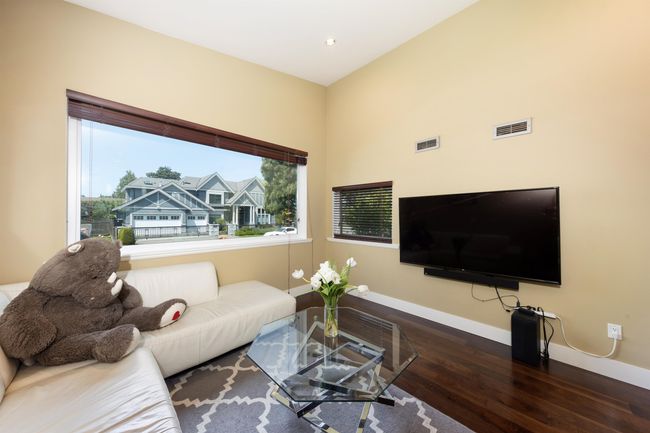 Living area with wood finished floors, baseboards, and recessed lighting | Image 11