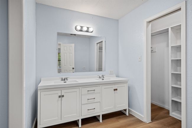 Full bath with wood finished floors, double vanity, and a spacious closet | Image 20