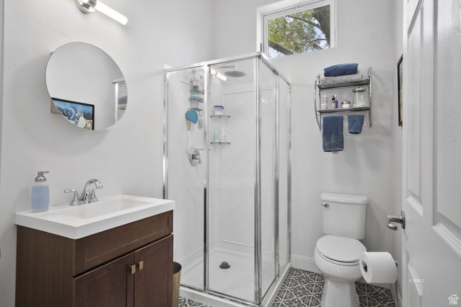 Full bathroom with toilet, vanity, and a shower-windows let in the fresh air | Image 10