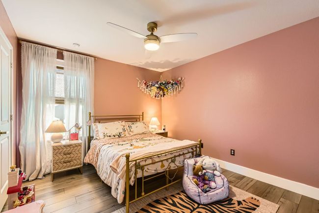 Bedroom featuring wood finished floors and a ceiling fan | Image 22