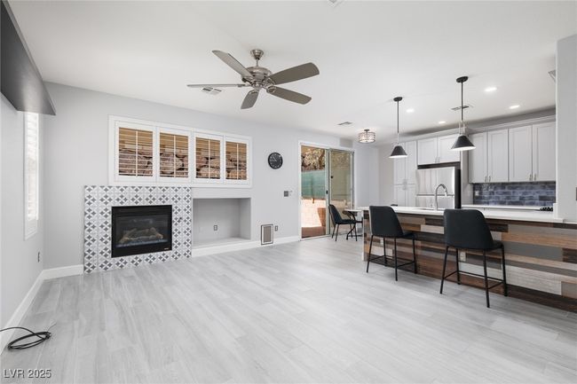 Living area with baseboards, a fireplace, recessed lighting, and ceiling fan | Image 9