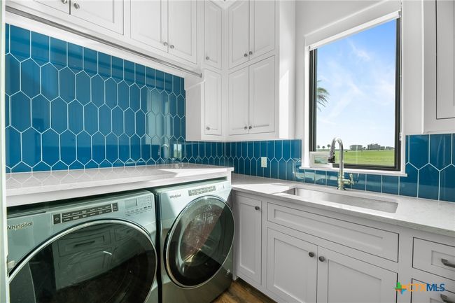 Laundry/Utility Room with a Sink, Broom Closet and Refrigerator | Image 11