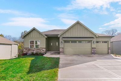 Craftsman house with a garage and a front lawn | Image 1