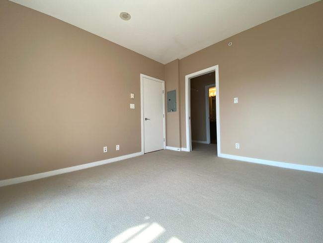 Unfurnished room featuring electric panel, carpet floors, and baseboards | Image 6