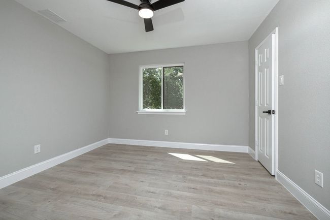Empty room featuring ceiling fan and light wood finished floors | Image 35