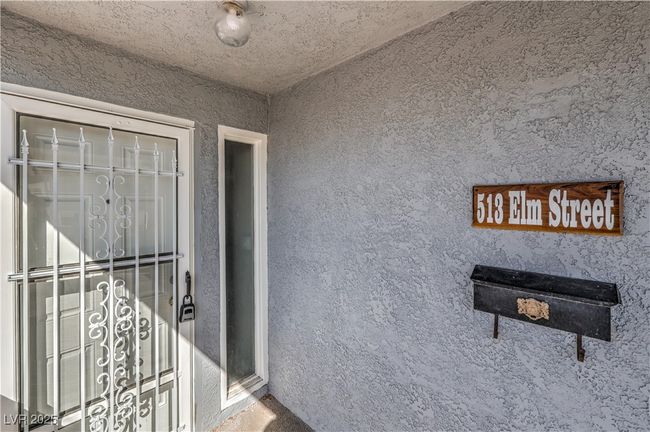 Entrance to property featuring stucco siding | Image 5