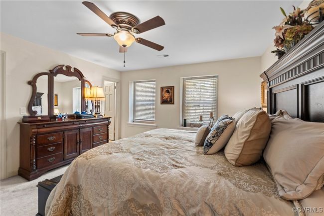 Bedroom featuring light carpet, visible vents, and ceiling fan | Image 30