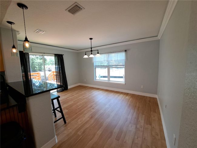 Off the Kitchen is the Dining room with exterior access to the new back deck and dog run area. | Image 10
