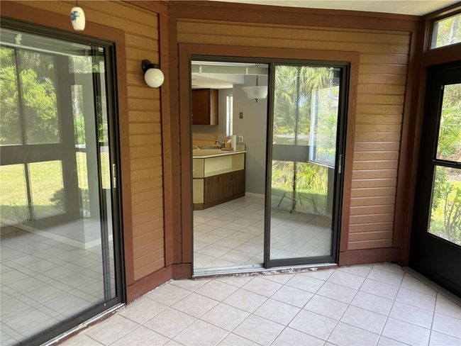 View into kitchen from screened lanai | Image 5