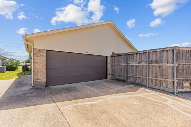 Detached garage featuring fence and central AC unit | Image 4