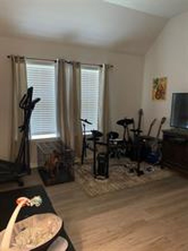 Exercise room featuring wood finished floors and vaulted ceiling | Image 13