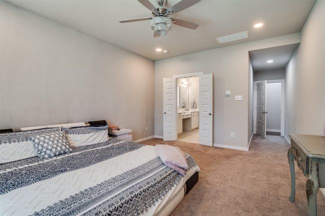 Bedroom featuring light colored carpet, recessed lighting, ensuite bathroom, and ceiling fan | Image 15