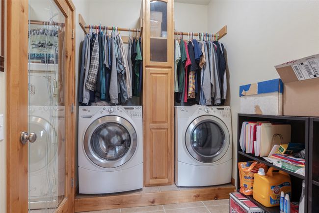 Washroom featuring washer / clothes dryer and tile patterned floors | Image 54