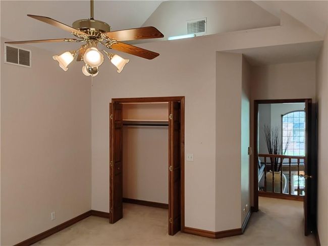 Upstairs bedroom #2 featuring a closet, oak baseboards, and light carpet | Image 75