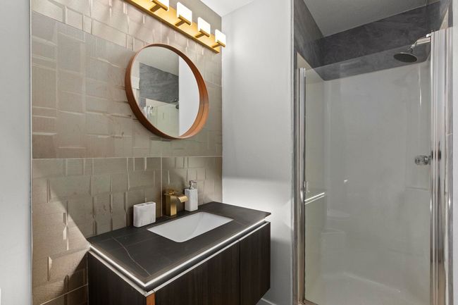 Bathroom with a shower stall, tasteful backsplash, and vanity | Image 19