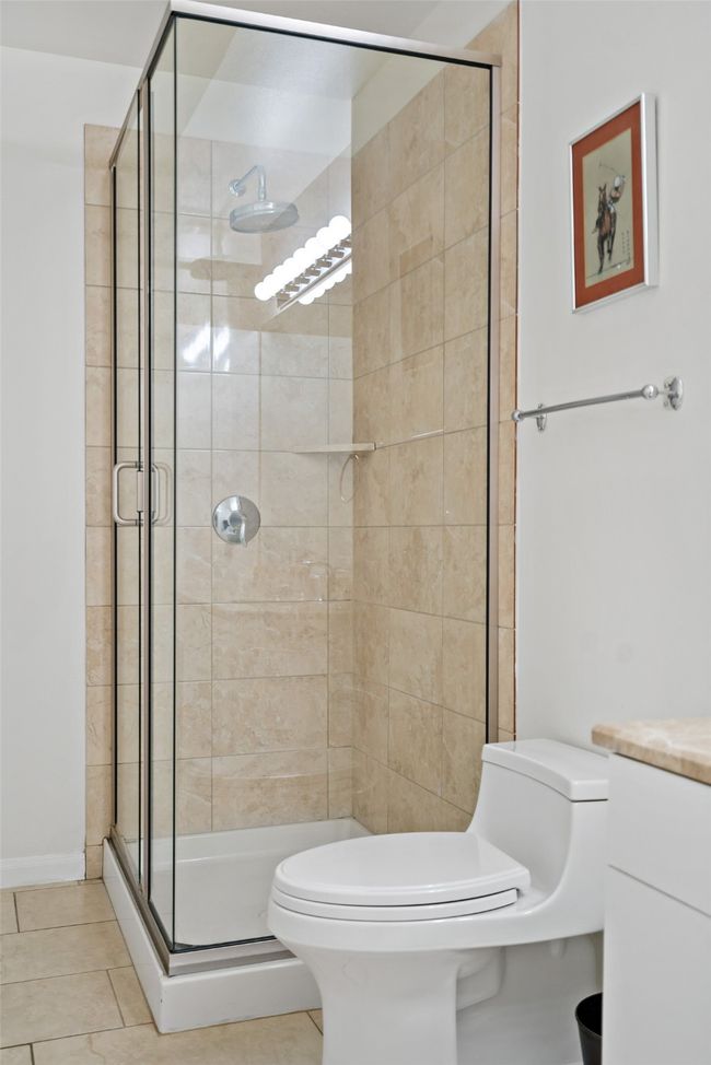 Full bathroom with tile patterned floors, a stall shower, and toilet | Image 14
