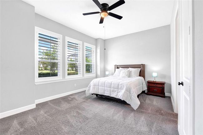 Extended ensuite bedroom downstairs with huge walk in closet and plantation shutters | Image 33